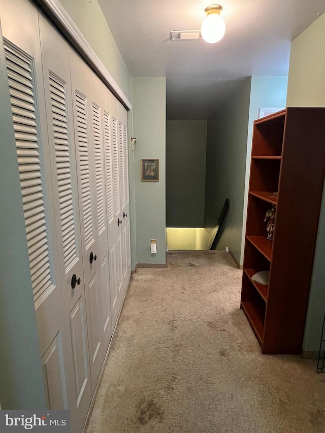 hallway with carpet flooring and visible vents