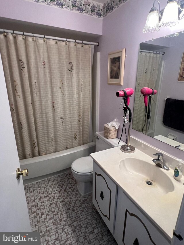 full bathroom featuring vanity, toilet, and shower / bath combination with curtain