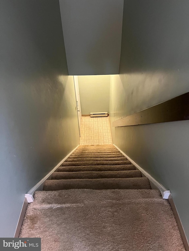 staircase featuring baseboards, carpet floors, and a baseboard radiator