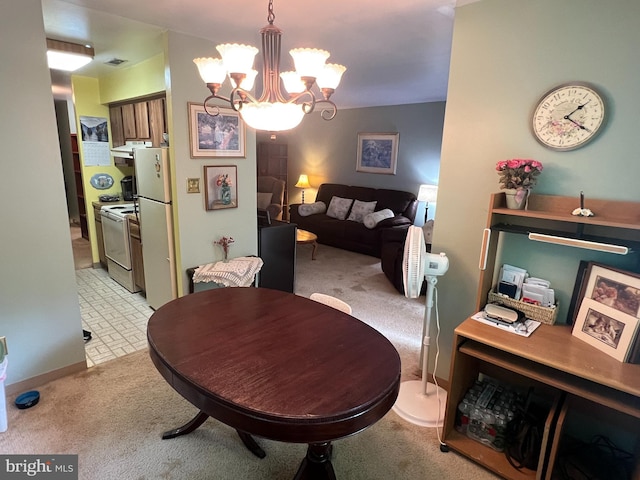 dining room featuring a notable chandelier, light colored carpet, and visible vents