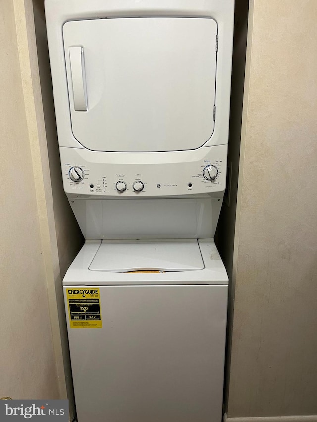 laundry area featuring stacked washer / dryer