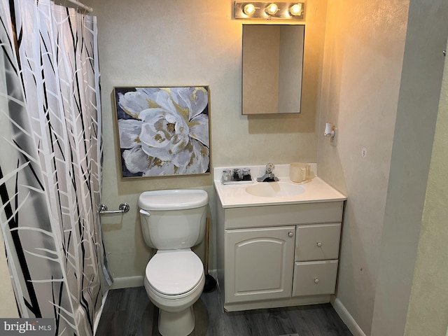 bathroom with vanity, toilet, a shower with shower curtain, and hardwood / wood-style flooring