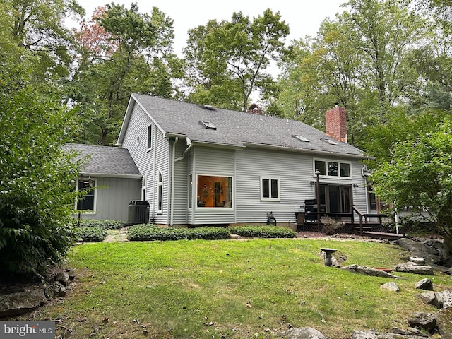 back of house with a yard, central AC unit, and a deck