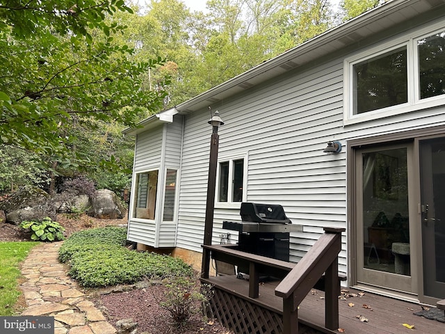 view of property exterior featuring a wooden deck