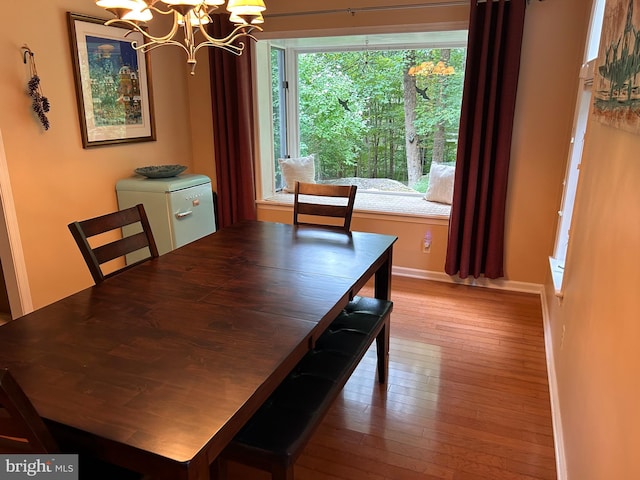 dining area featuring a notable chandelier and light hardwood / wood-style floors