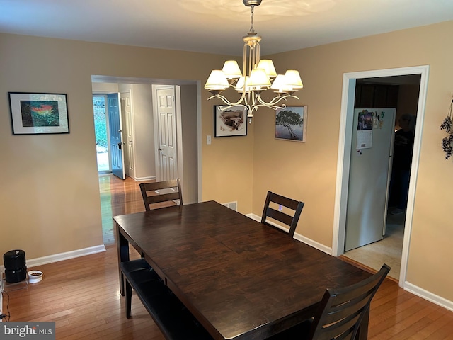 dining room featuring an inviting chandelier and light hardwood / wood-style floors