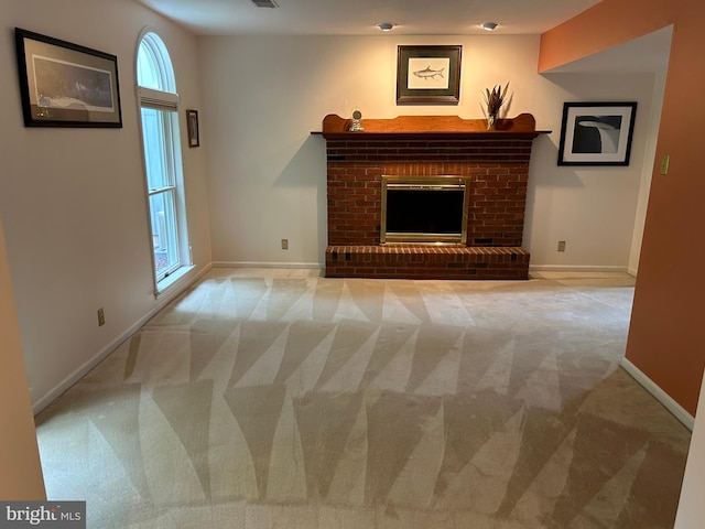 unfurnished living room with a brick fireplace and carpet floors