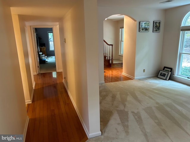 hallway with light hardwood / wood-style floors