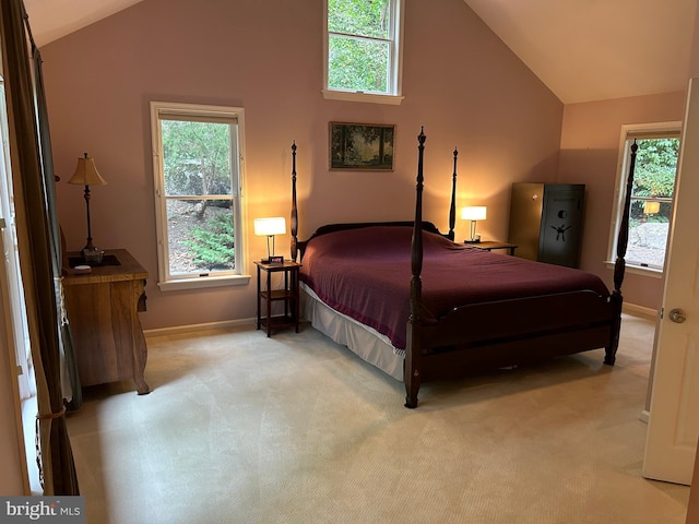 bedroom featuring multiple windows, carpet, and vaulted ceiling