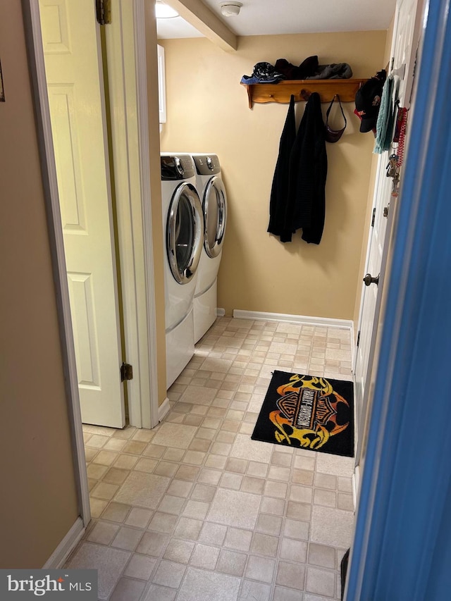 clothes washing area featuring separate washer and dryer