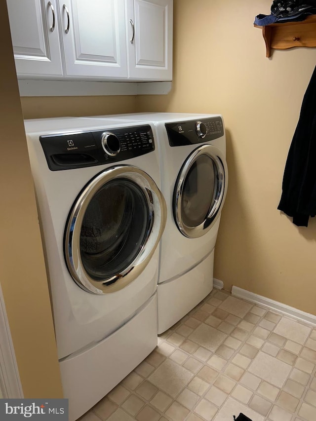 laundry area with cabinets and washer and dryer