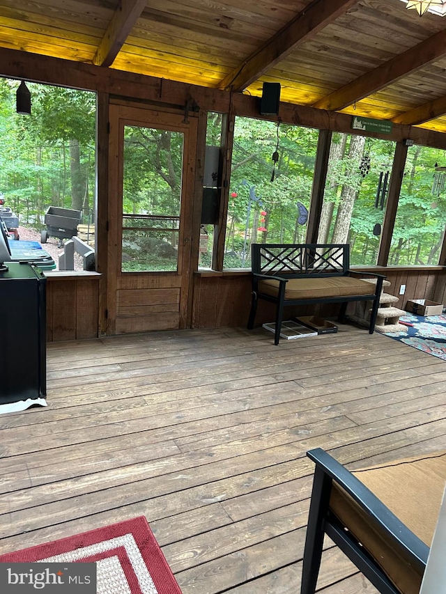 sunroom with wood ceiling and beam ceiling