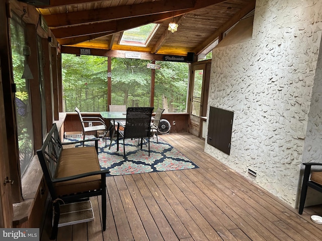 unfurnished sunroom featuring wooden ceiling and lofted ceiling with skylight