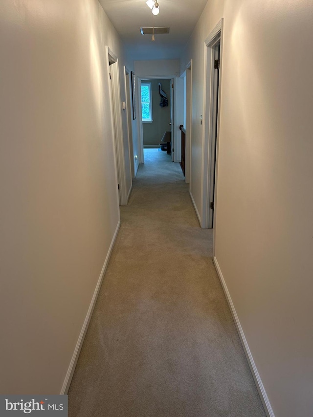 hallway with light colored carpet