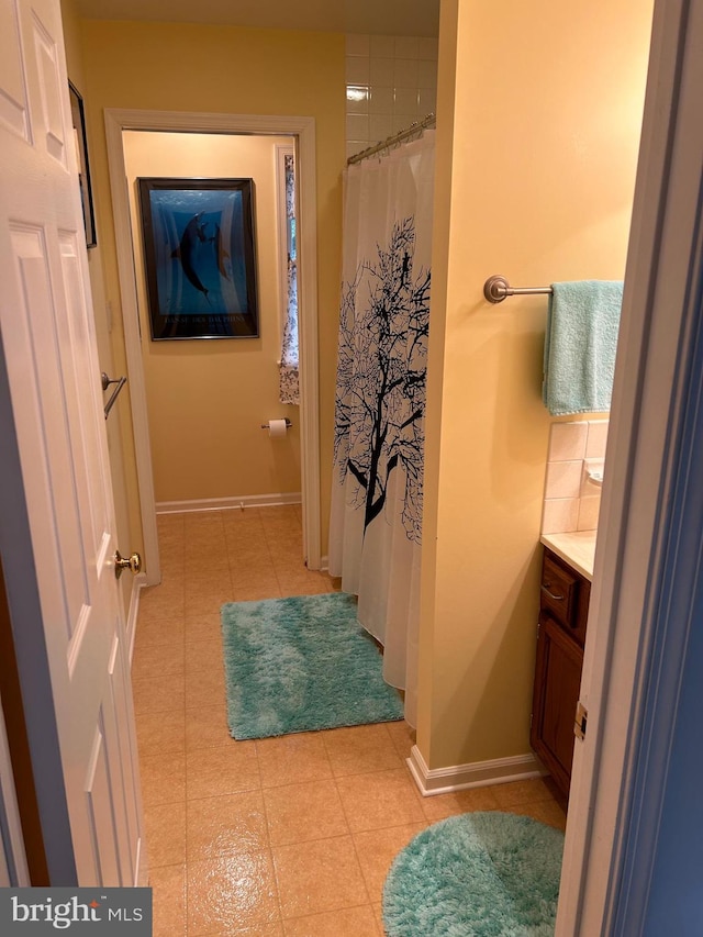 bathroom featuring tile patterned flooring, vanity, and a shower with shower curtain