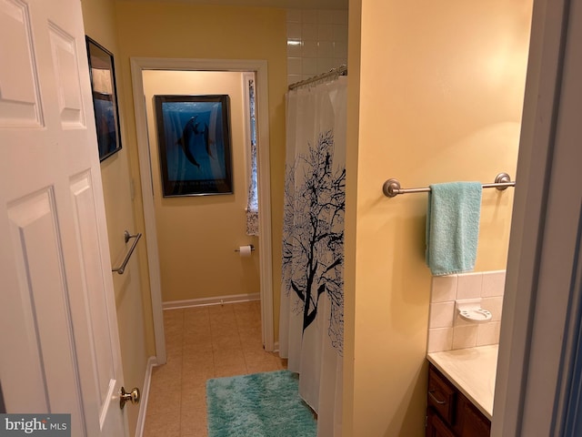 bathroom featuring vanity, walk in shower, and tile patterned flooring