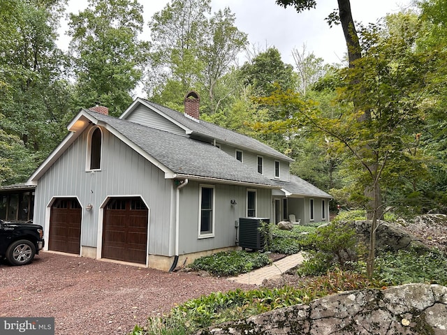 view of front of house featuring a garage and central air condition unit