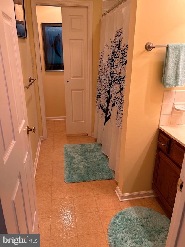 bathroom featuring tile patterned flooring, vanity, and a shower with curtain