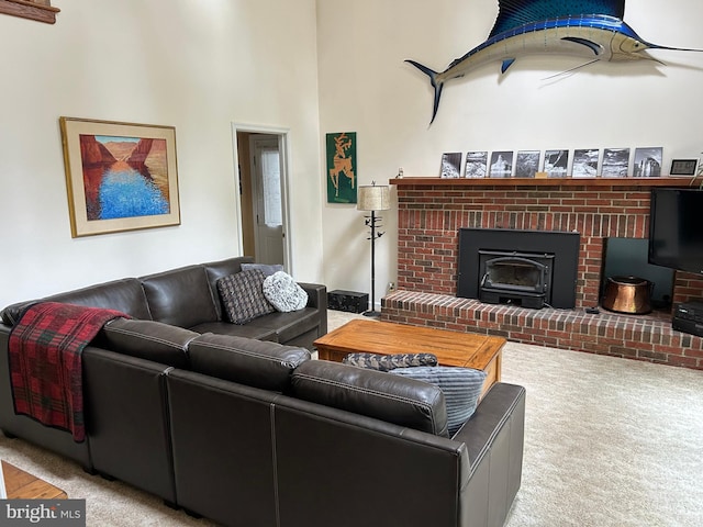 living room with light carpet and a brick fireplace