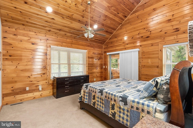 carpeted bedroom featuring wooden ceiling, multiple windows, ceiling fan, and wooden walls