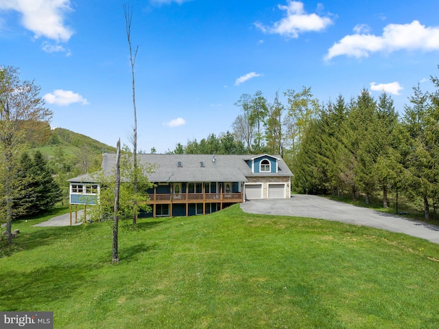 view of front of property with a garage and a front yard