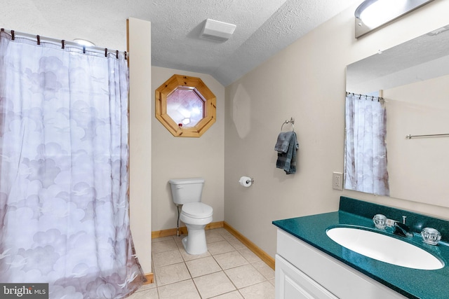 bathroom featuring toilet, tile patterned floors, vanity, a textured ceiling, and vaulted ceiling