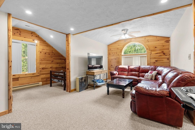 carpeted living room with a textured ceiling, a healthy amount of sunlight, baseboard heating, and ceiling fan