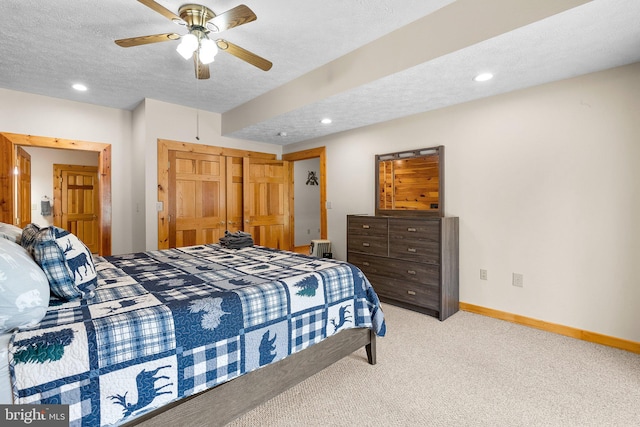 bedroom with light carpet, a textured ceiling, and ceiling fan