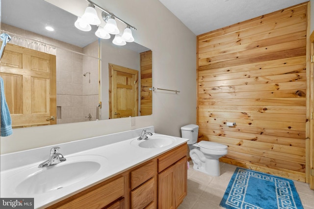 bathroom with wood walls, walk in shower, toilet, and vanity