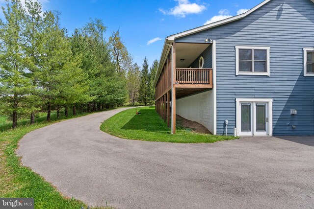 view of side of home with a lawn