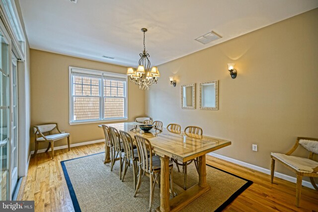 dining room featuring an inviting chandelier and light hardwood / wood-style floors