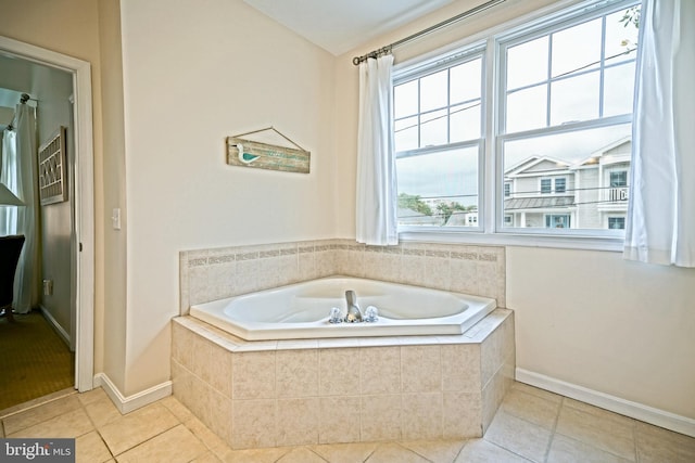 bathroom with tiled bath and tile patterned floors