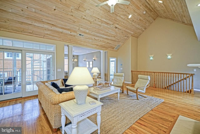 living room with light wood-type flooring, wood ceiling, ceiling fan, and high vaulted ceiling