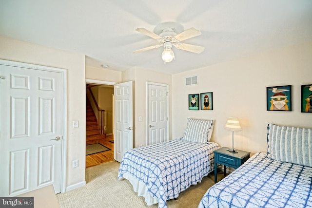 bedroom with ceiling fan and light carpet