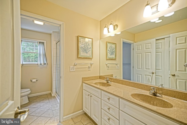 bathroom with vanity, tile patterned floors, an enclosed shower, and toilet