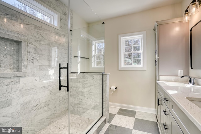 bathroom featuring vanity, plenty of natural light, and a shower with shower door