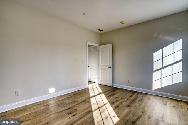 spare room featuring wood-type flooring