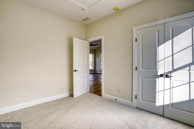 interior space featuring light colored carpet and ceiling fan