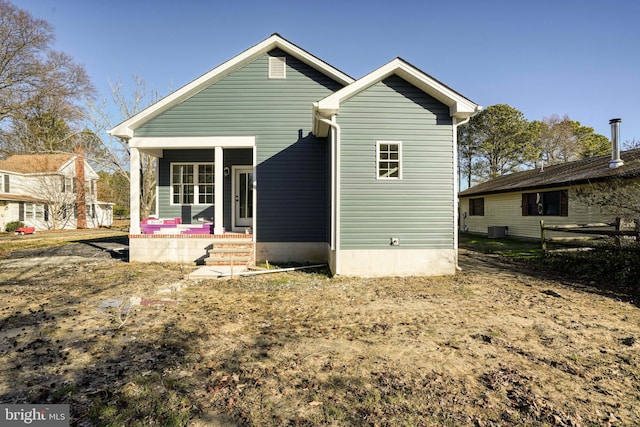 rear view of house featuring covered porch and central AC