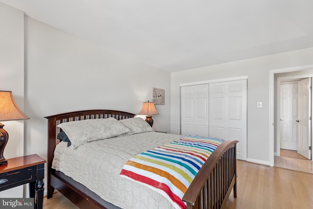 bedroom with a closet and light hardwood / wood-style floors