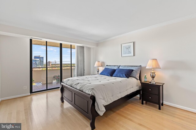 bedroom with light wood-type flooring, access to outside, and ornamental molding