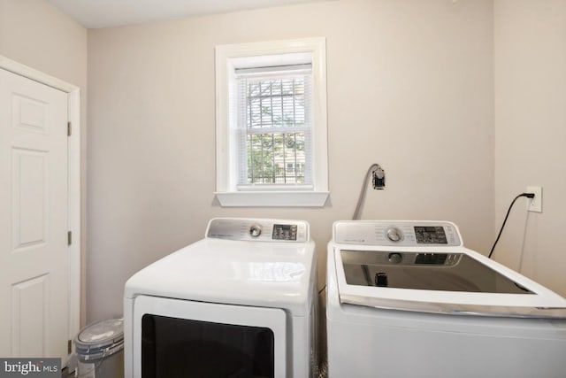 washroom with washing machine and clothes dryer