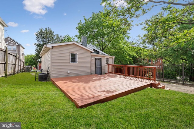 back of property featuring a yard, cooling unit, and a deck