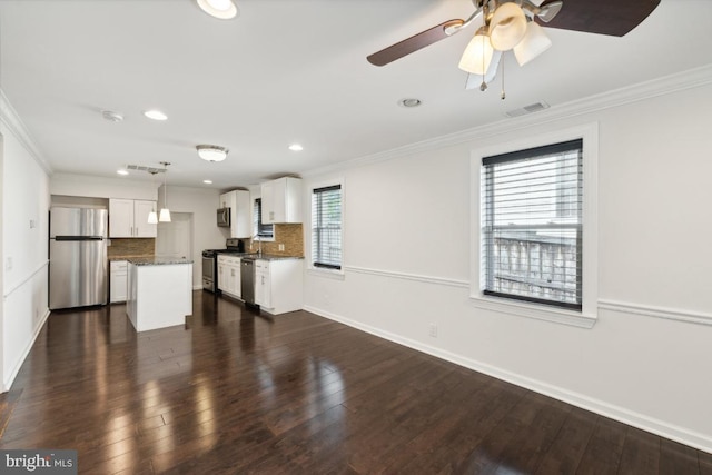 unfurnished living room featuring crown molding, ceiling fan, dark hardwood / wood-style floors, and sink