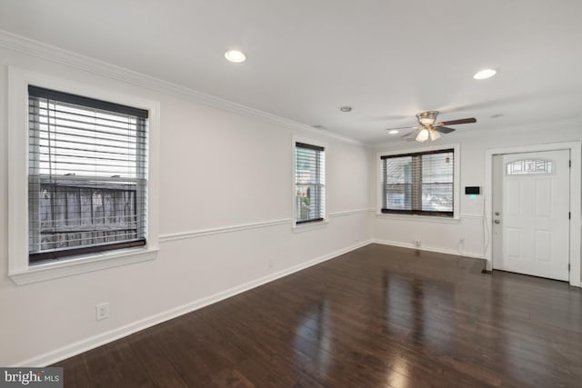 spare room featuring ornamental molding, dark hardwood / wood-style flooring, and ceiling fan