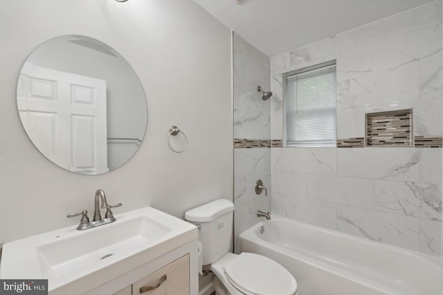 full bathroom featuring tiled shower / bath combo, vanity, and toilet