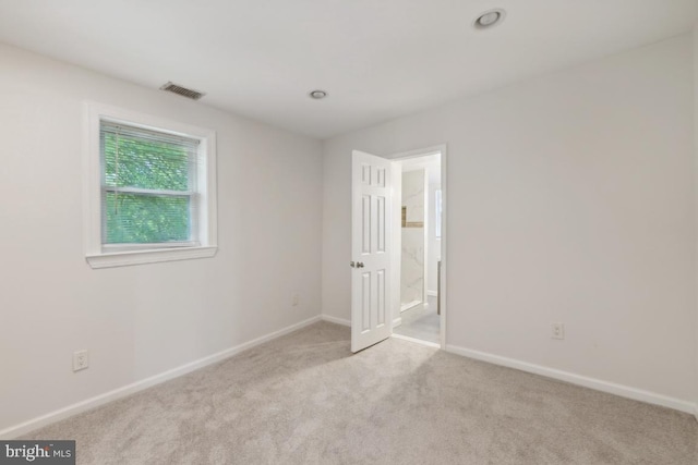 empty room featuring light colored carpet