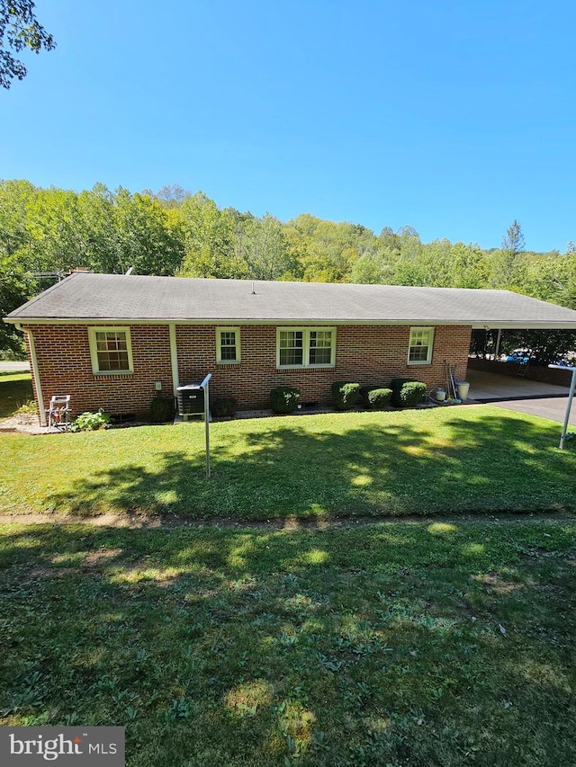 ranch-style house with a front lawn and a carport