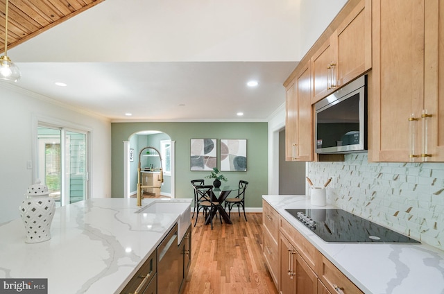 kitchen featuring tasteful backsplash, black electric cooktop, ornamental molding, light hardwood / wood-style floors, and light stone counters