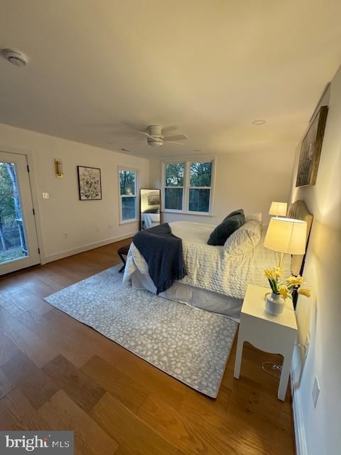 bedroom with access to outside, wood-type flooring, and ceiling fan